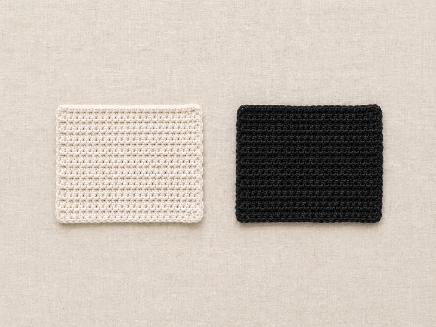 Matching crochet swatches in cream and black yarn photographed under identical light to compare stitch visibility.