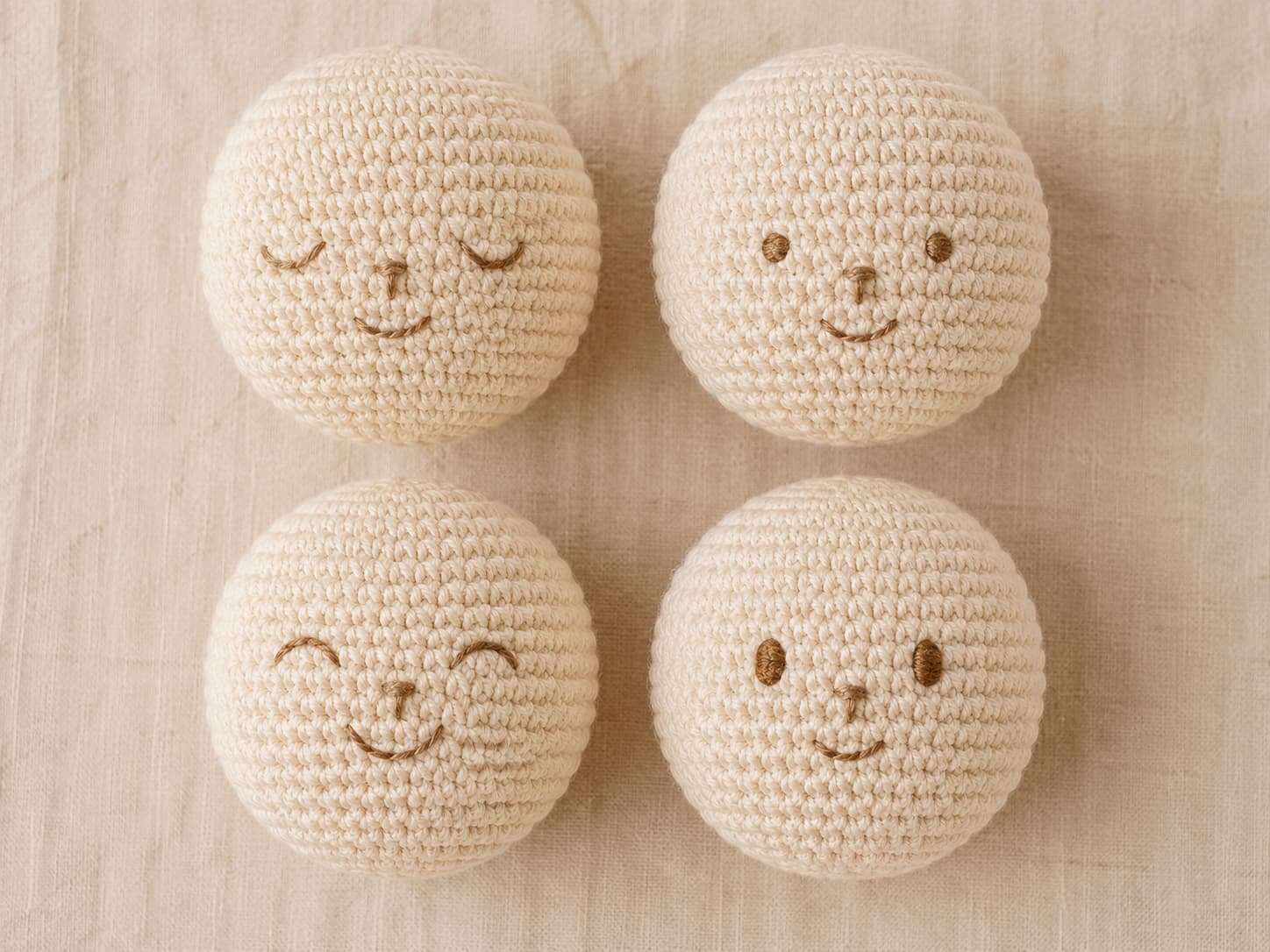 Baby-safe crochet amigurumi faces with fully embroidered eyes, noses, and mouths and no detachable plastic features.