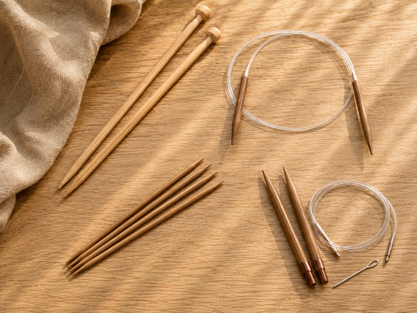 Straight knitting needles, a fixed circular needle, double-pointed needles, and interchangeable tips arranged side by side.