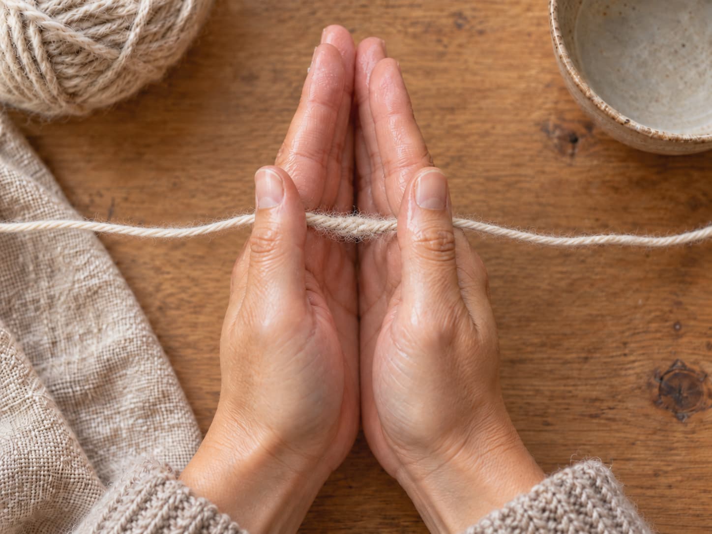 Two wool yarn ends overlapped and rubbed between damp palms to create a felted join